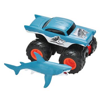 A blue toy truck with a shark design attached to one of the tires, representing the Wild Republic Hammerhead Shark & Adventure Truck.