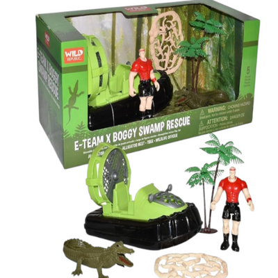 A toy playset featuring a green alligator, a swamp environment, and two figures including a rescuer and a driver.